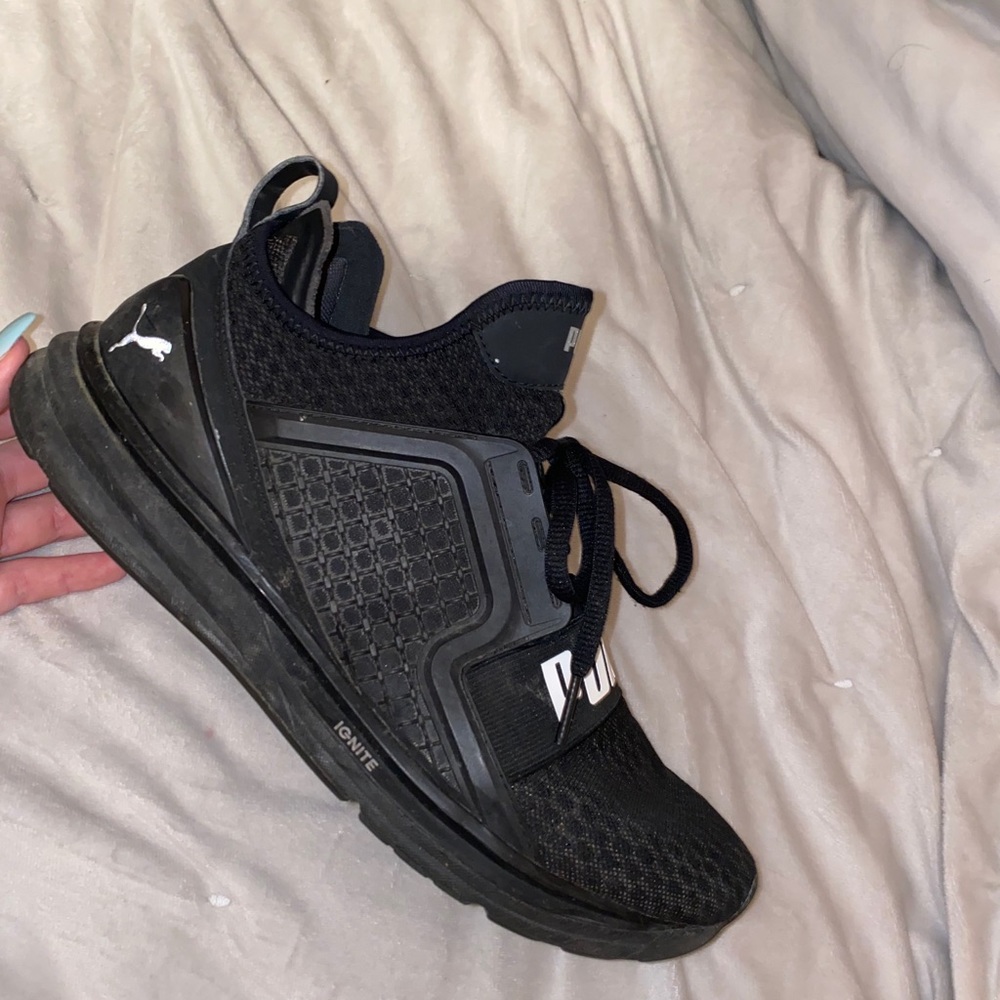All black Puma running shoes